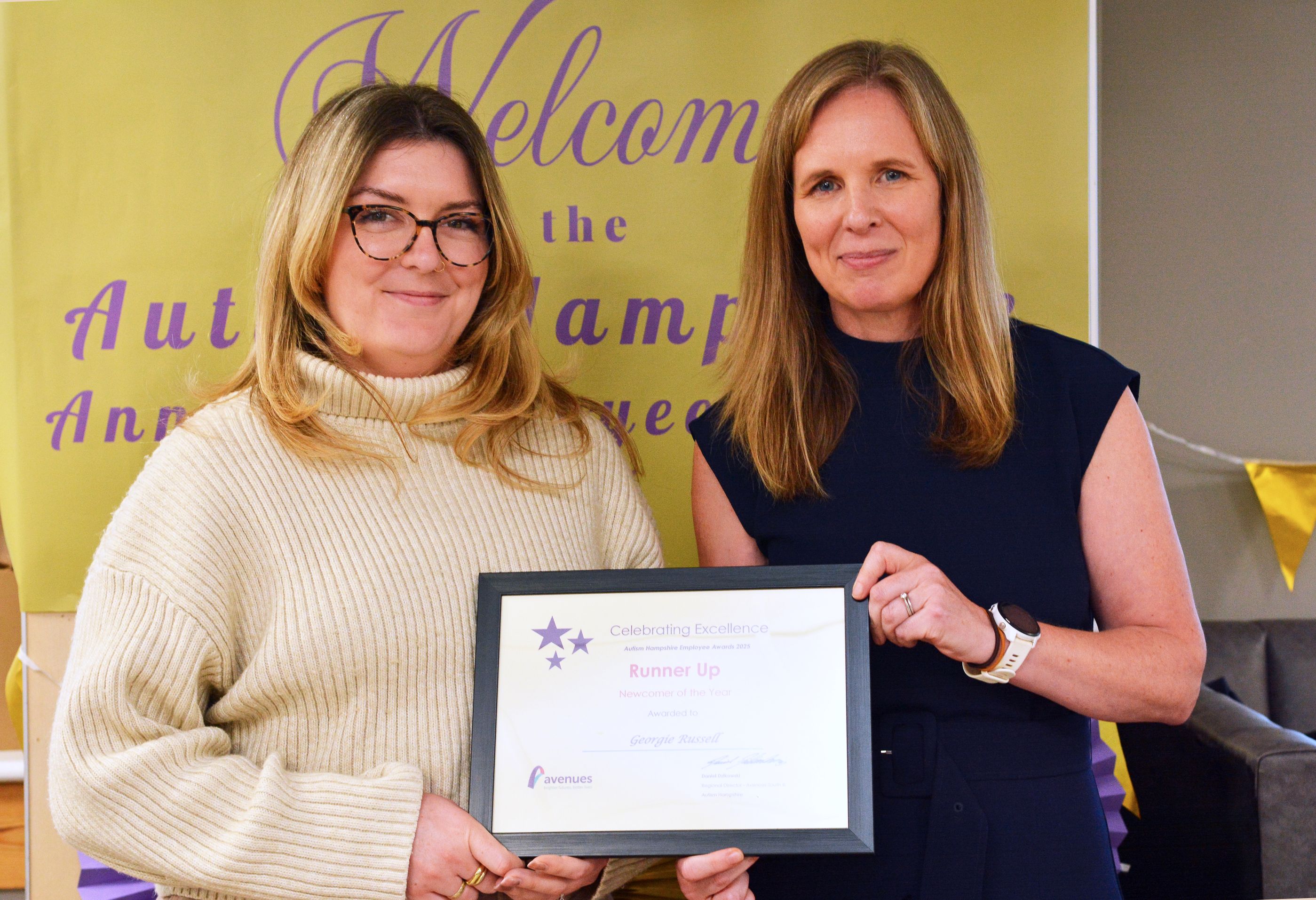 Georgie Russell is presented with an award by Karina Hourd