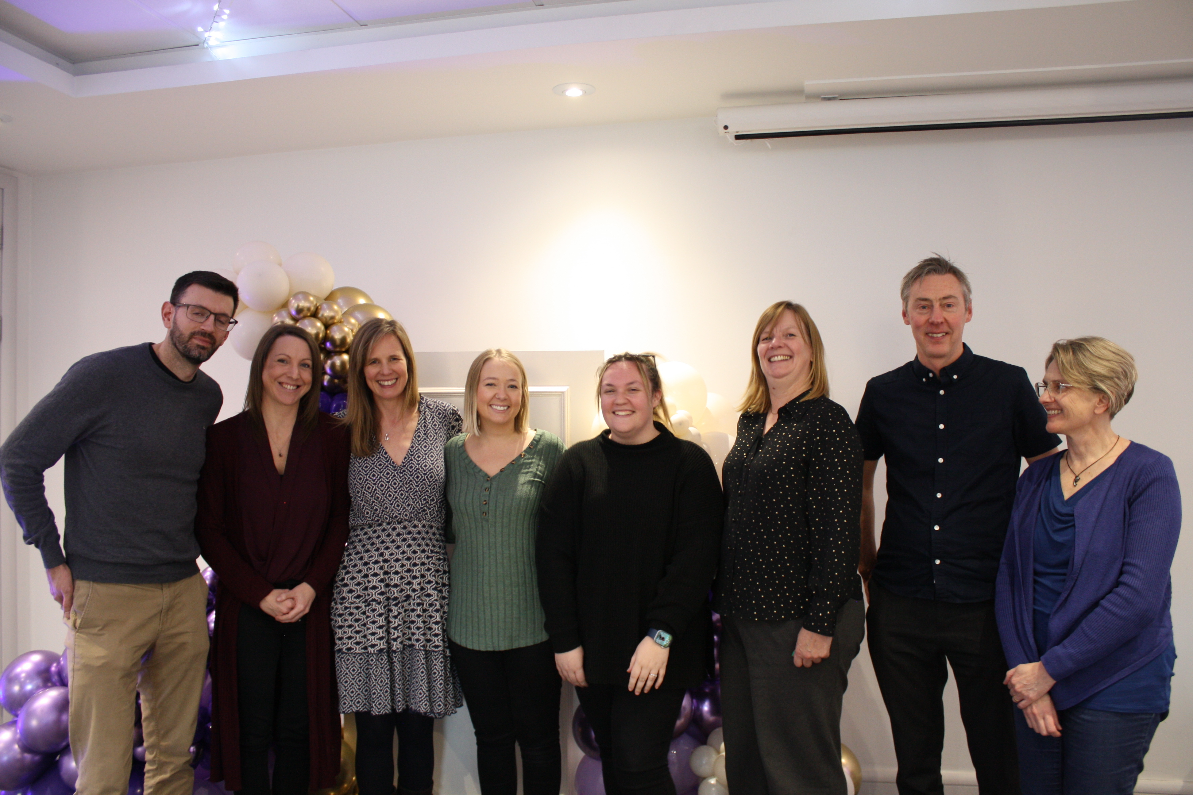 Colleagues gather together at the employee celebration event.