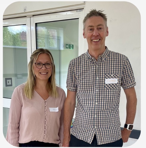 A photo of Laura and Richard - a blonde woman in a pink top and a tall man in a check shirt