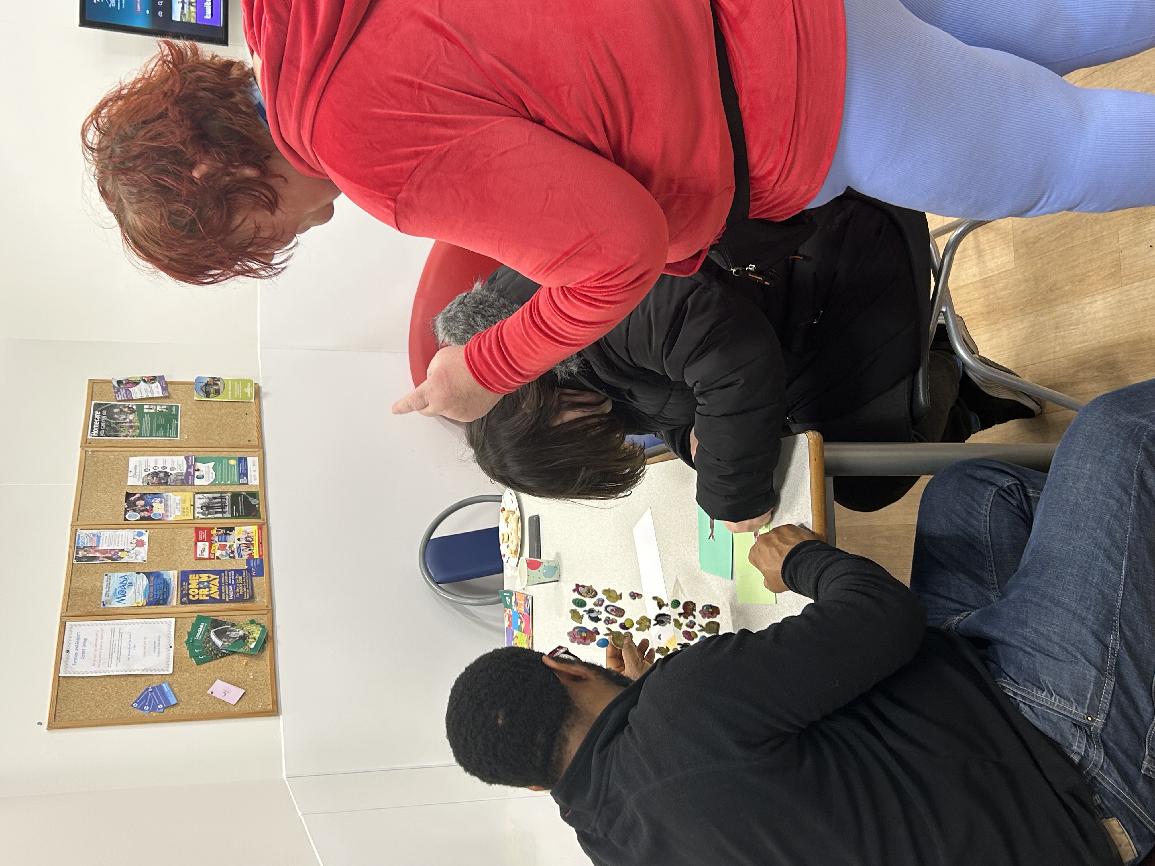 A man and two woman taking part in arts and crafts